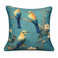 Teal scatter cushion with three illustrated bee-eater birds perched among branches and soft blossoms