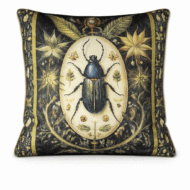 Black scatter cushion featuring an ornate blue scarab beetle illustration framed by antique gold botanical detail