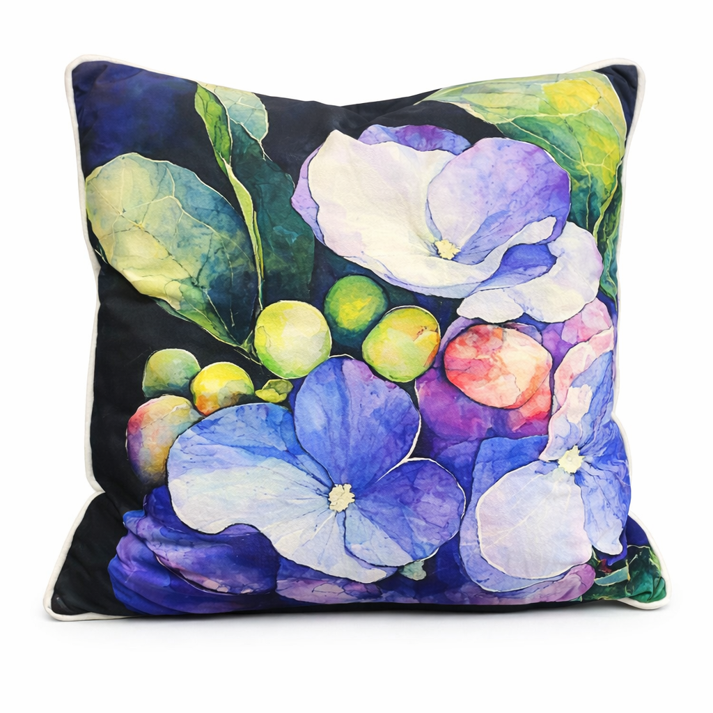 Black scatter cushion with watercolor hydrangea blooms in blue, lilac, and soft pink against dark green foliage