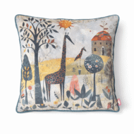 Whimsical scatter cushion with illustrated giraffes in a naive-style winter landscape with a cottage and stylized trees