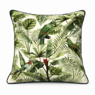 Cream scatter cushion with lush jungle foliage print featuring vibrant green and red parrots among palm leaves