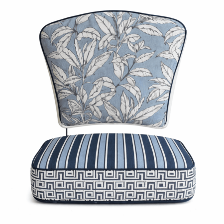 Blue and white outdoor canvas chair cushion set with botanical leaf back cushion and striped geometric seat cushion