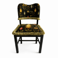 Black wood chair with beetle and botanical print upholstery and fringed trim.