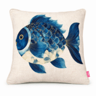 Neutral scatter cushion featuring a round illustrated blue fish with gold-accented scales