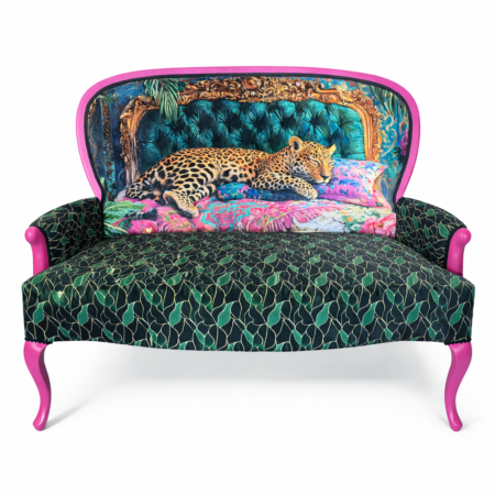 Upcycled settee with teal tufted leopard print backrest, green leaf print seat, and pink legs.