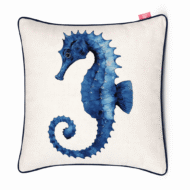 Ivory scatter cushion with detailed blue watercolor seahorse illustration and navy piping