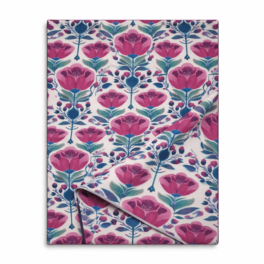 Ivory table runner with bold pink floral print and teal botanical stems, folded to show fabric texture