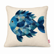 Neutral scatter cushion featuring a round illustrated blue fish with layered turquoise, navy, and aqua scale patterns