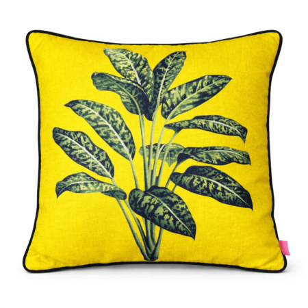 Bright acid yellow scatter cushion with a bold tropical variegated leaf print and black piping