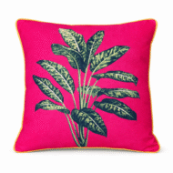 Vibrant cherise pink scatter cushion with a bold tropical variegated leaf print and yellow piping