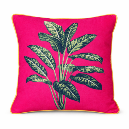 Vibrant cherise pink scatter cushion with a bold tropical variegated leaf print and yellow piping