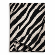 Zebra print table runner in black and neutral tones, folded to show fabric texture