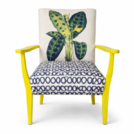 Yellow painted accent chair with a white botanical print cushion.