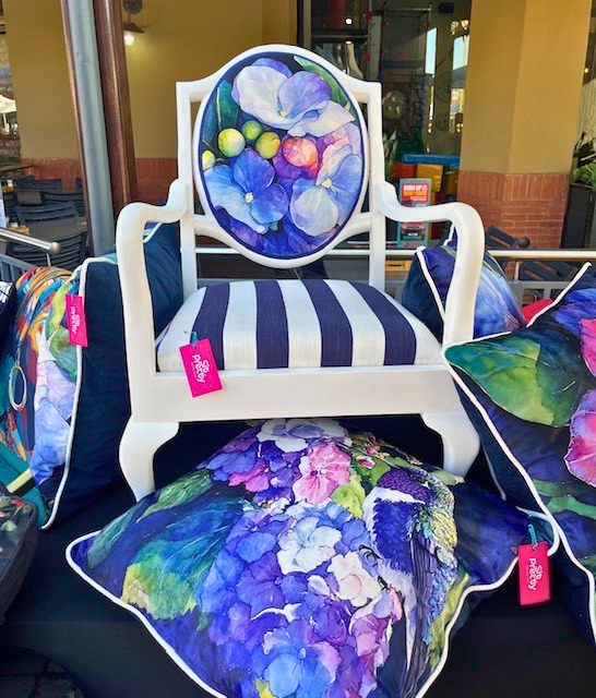 White accent chair with hand-painted hydrangea floral back panel and striped seat.